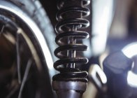 Close-up of motorbike shock absorber in workshop — Stock Photo