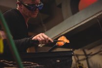 Glassblower shaping molten glass at glassblowing factory — Stock Photo