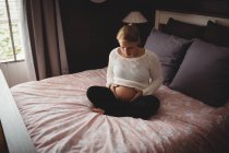Pregnant woman relaxing in bedroom at home — Stock Photo
