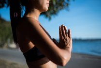 Cropped image of woman practicing yoga in park on sunny day — Stock Photo