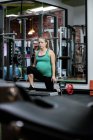 Pregnant woman performing exercise in gym — Stock Photo