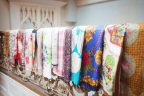 Various fabric on railings at boutique store — Stock Photo