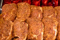 Close-up of marinated meat at display counter — Stock Photo