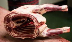 Pork carcass kept on table at butchers shop — Stock Photo