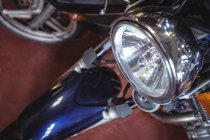 Headlight of motorcycle in industrial mechanical workshop — Stock Photo