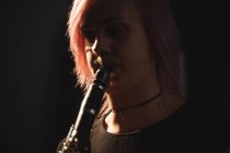 Close-up of woman playing a clarinet in music school — Stock Photo