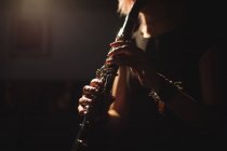 Mid-section of woman playing a clarinet in music school — Stock Photo