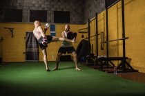 Boxers tailandeses esportivos praticando boxe no ginásio — Fotografia de Stock
