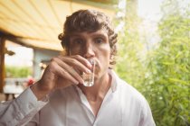 Portrait of man having tequila shot in bar — Stock Photo