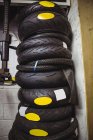 Stack of various tyres in industrial mechanical workshop — Stock Photo