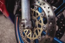 Close-up of motorcycle disc brake in workshop — Stock Photo