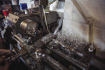 Механічна робота над промисловим токарним верстатом у майстерні — стокове фото