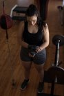Hermosa boxeadora femenina con envoltura de mano en estudio de fitness - foto de stock