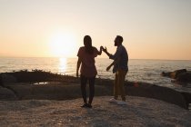 Romantic couple standing near sea side — Stock Photo