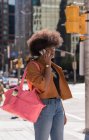 Жінка розмовляє по мобільному телефону в місті в сонячний день — стокове фото