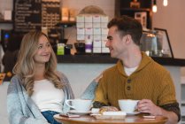 Couple heureux interagissant les uns avec les autres dans le café — Photo de stock
