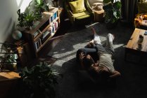 Couple sleeping on floor in living room at home — Stock Photo