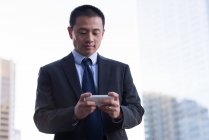 Businessman using mobile phone on balcony at hotel — Stock Photo