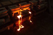 Molten metal in moulds at foundry — Stock Photo