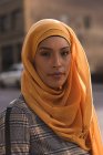 Portrait of hijab woman looking at camera in city — Stock Photo