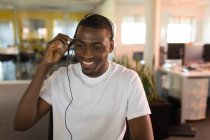 Smiling business executive talking with client in headset — Stock Photo