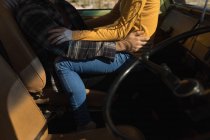 Partie basse du couple embrassant dans le véhicule — Photo de stock