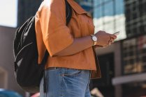 Mid section of woman using mobile phone in city — Stock Photo
