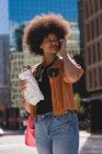 Woman talking on mobile phone in city on a sunny day — Stock Photo