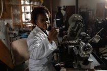 Жінка-працівник вивчає склопродукт на скляній фабриці — стокове фото