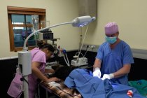 Chirurgien opérant un chien en salle d'opération à l'hôpital vétérinaire — Photo de stock