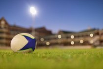 Close-up of a rugby ball in the stadium at dusk — Stock Photo