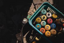 Vista ad alto angolo di bombolette aerosol colorate tenute nel carrello — Foto stock