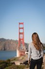 Rear view of thoughtful woman looking at bridge — Stock Photo