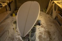 New surfboard on a repair stand in workshop — Stock Photo