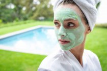 Front view of woman in face mask looking away near poolside — Stock Photo