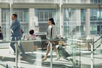 Side view of diverse business people walking in modern office — Stock Photo