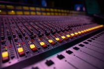Close up of the channels and controls on a multitrack mixing desk in a recording studio — Stock Photo