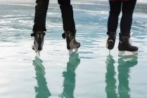 Half length of couple together skating in natural snowy landscape — Stock Photo