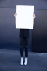 Front view of man holding a blank sign board — Stock Photo