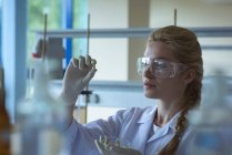 Attentive university student doing a experiment in laboratory — Stock Photo