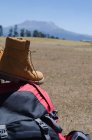 Close up of boots on backpack at field — Stock Photo