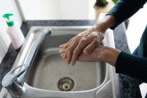 Hands of woman spending time at home, washing her hands. Lifestyle at home isolating, social distancing in quarantine lockdown during coronavirus covid 19 pandemic. — Stock Photo
