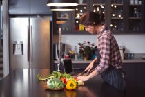 Mixed race woman spending time at home self isolating and social distancing in quarantine lockdown during coronavirus covid 19 epidemic, preparing food cooking in kitchen — Stock Photo