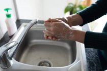 Hands of woman spending time at home, washing her hands. Lifestyle at home isolating, social distancing in quarantine lockdown during coronavirus covid 19 pandemic. — Stock Photo