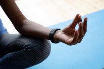 Close up of african american woman practicing yoga at home. staying at home in self isolation in quarantine lockdown — Stock Photo