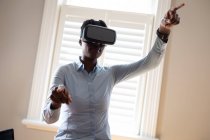 African american woman using vr headset in kitchen. staying at home in self isolation during quarantine lockdown. — Stock Photo