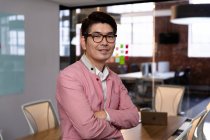 Portrait of stylish asian businessman smiling to camera. business person at work in modern office. — Stock Photo