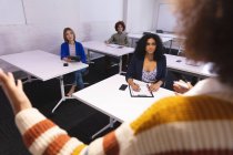 Diverse group of creative business colleagues in meeting room listening presentation taking notes. independent creative design business. — Stock Photo