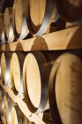 Close up view of multiple wooden barrels at gin distillery. alcohol production and filtration concept — Stock Photo