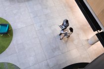 Overhead view of diverse businessman and businesswoman discussing together at modern office. business and office concept — Stock Photo